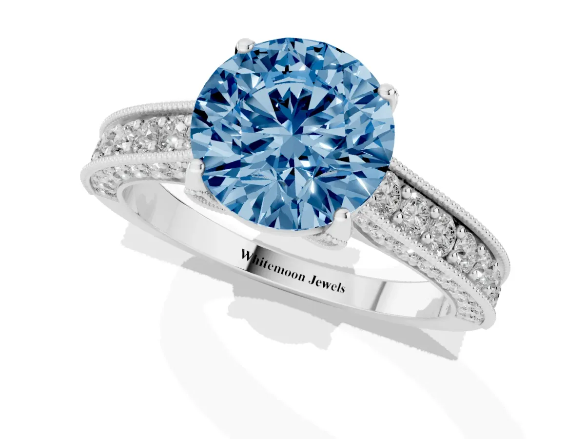 Fancy Blue Round Cut Cut Diamond Solitaire Ring with Milgrain Pave Band and Four Prong Setting Silver