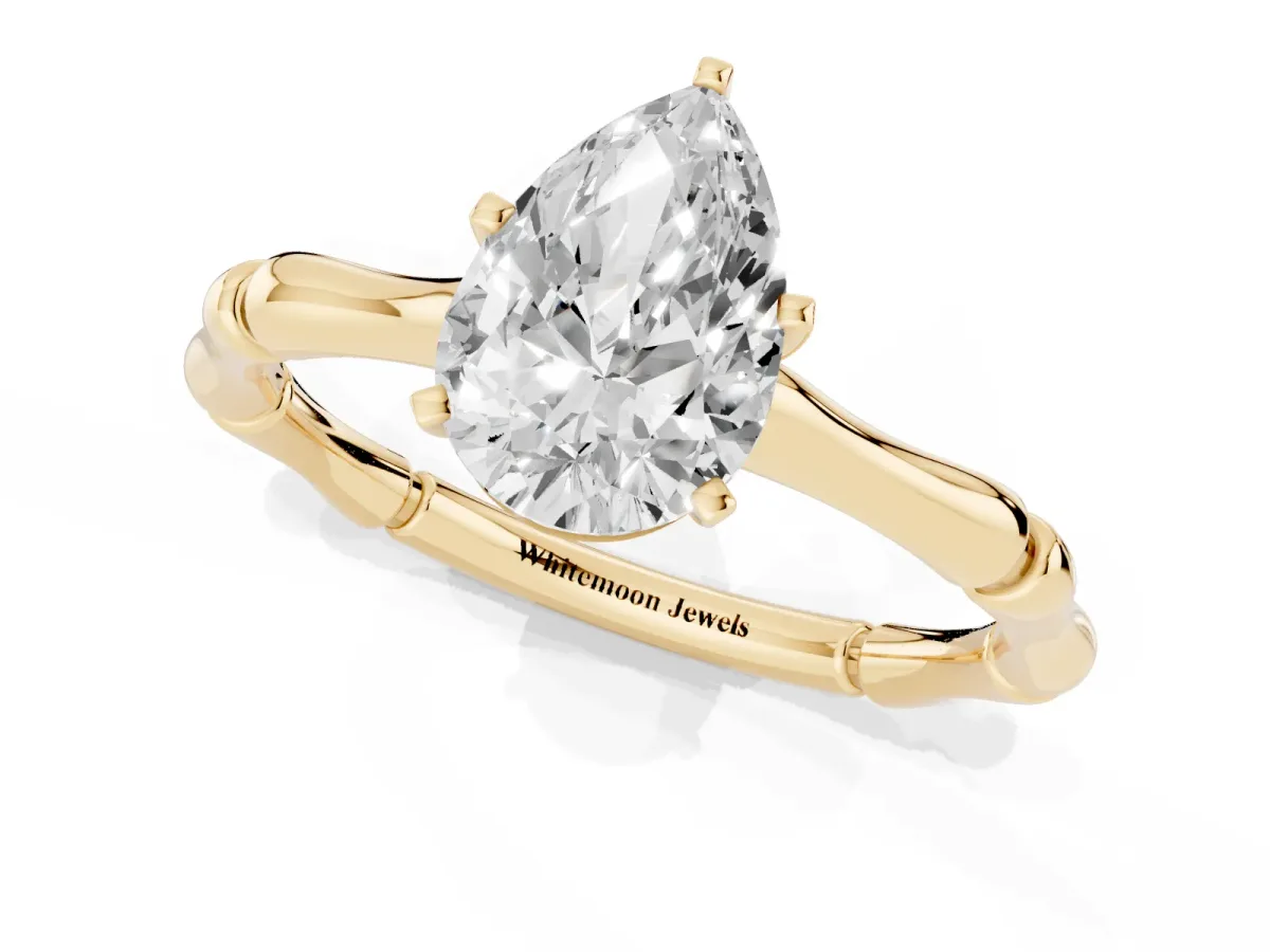Pear Cut Solitaire Diamond Ring with Bamboo Band and Four-Prong Setting Yellow gold