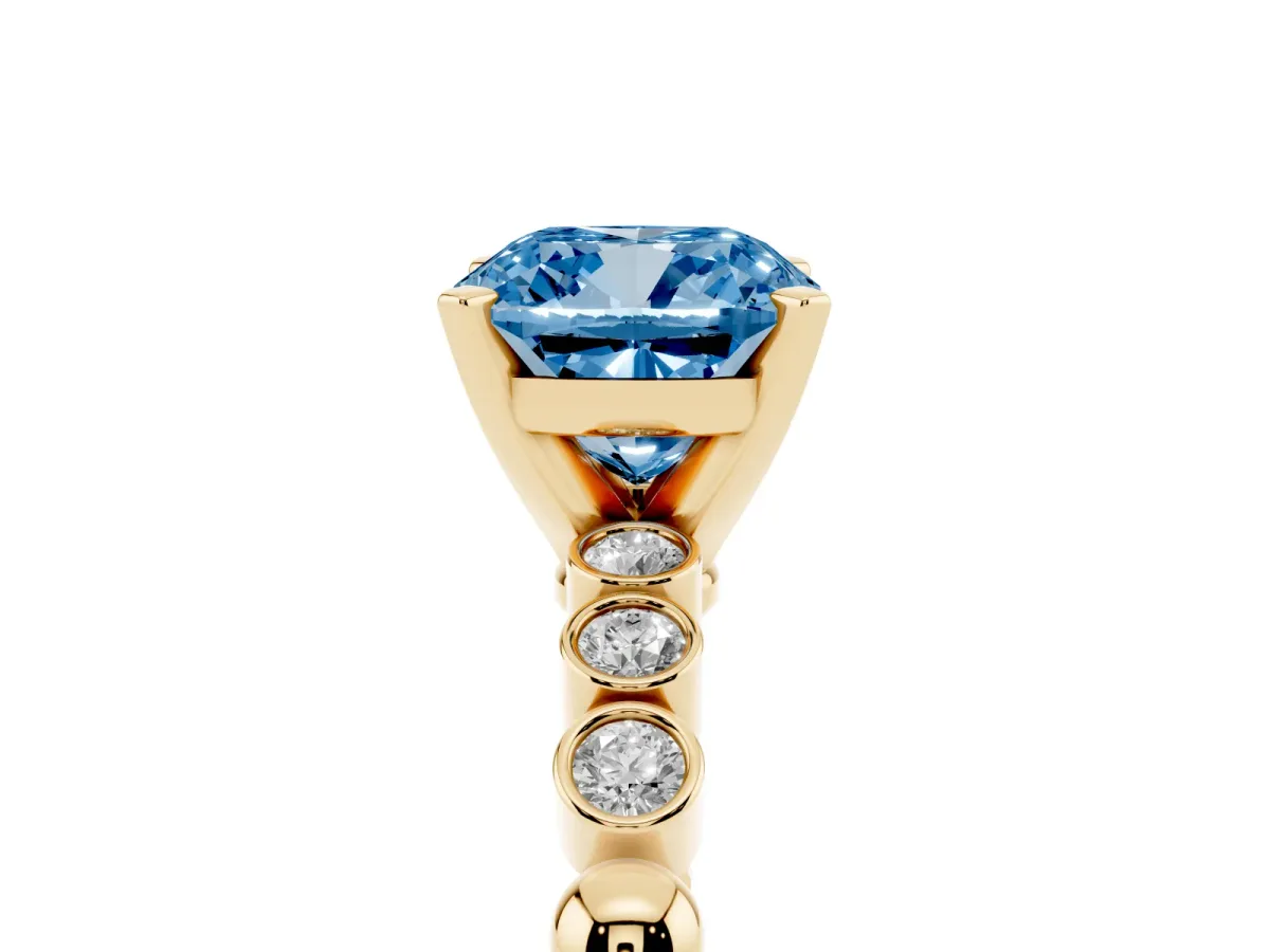Fancy Blue Cushion Cut Solitaire Bezel Accent Diamond Engagement Ring with Beaded Band and Four-Prong Setting Yellow gold