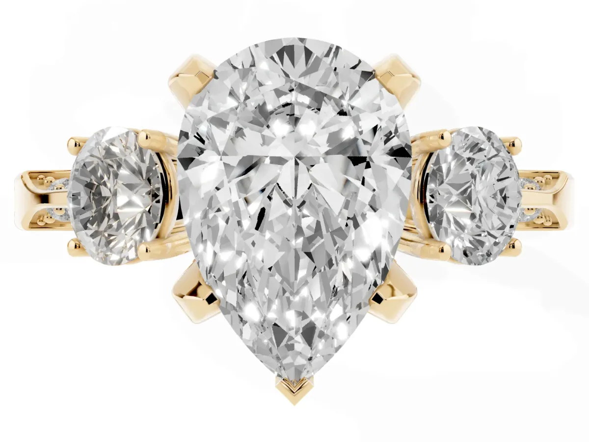 Pear Cut Brilliant Three-Stone Diamond Ring with Pavé Band and Four-Prong Setting Yellow gold
