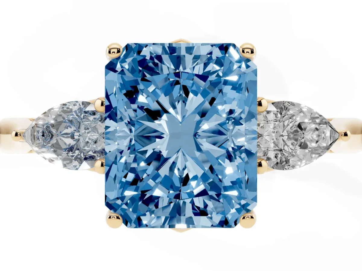 Fancy Blue Radiant Cut Diamond Three-Stone Ring with Pear Side Stones and Prong Setting Yellow gold