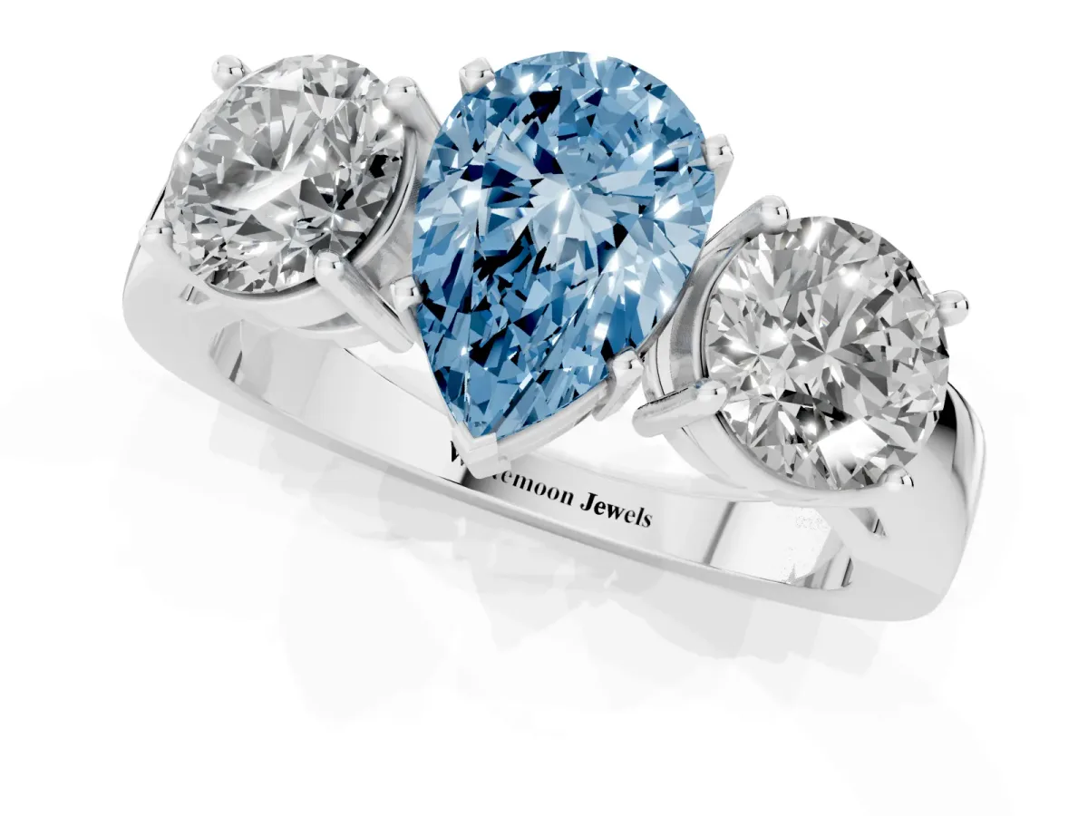 Fancy Blue Three-Stone Pear Cut Diamond Ring with Round Side Stones, Classic Band, and Four-Prong Setting White gold