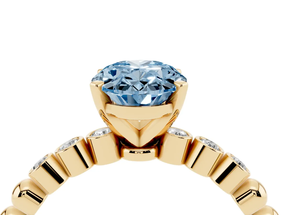 Fancy Blue Oval Cut Solitaire Bezel Accent Diamond Engagement Ring with Beaded Band and Four-Prong Setting Yellow gold