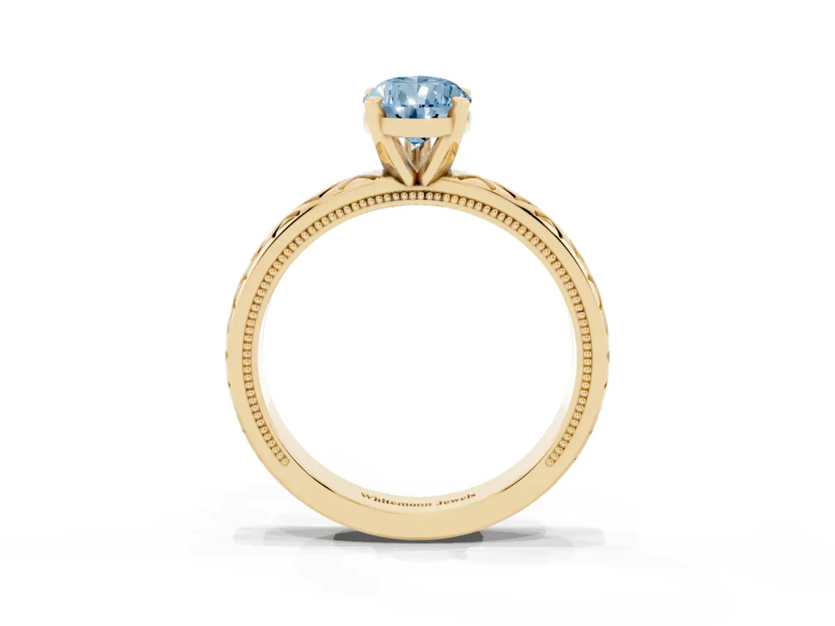 Fancy Blue Pear Cut Solitaire Diamond Ring with Milgrain and Black Enamel X Pattern Band Yellow gold