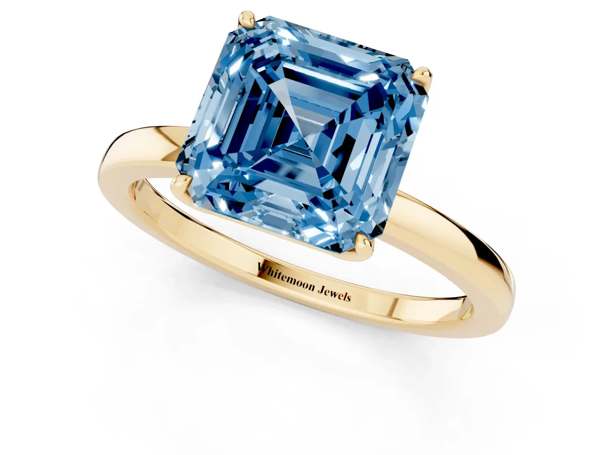 Fancy Blue Asscher Cut Diamond Solitaire Ring with Thin Band and Prong Setting Yellow gold