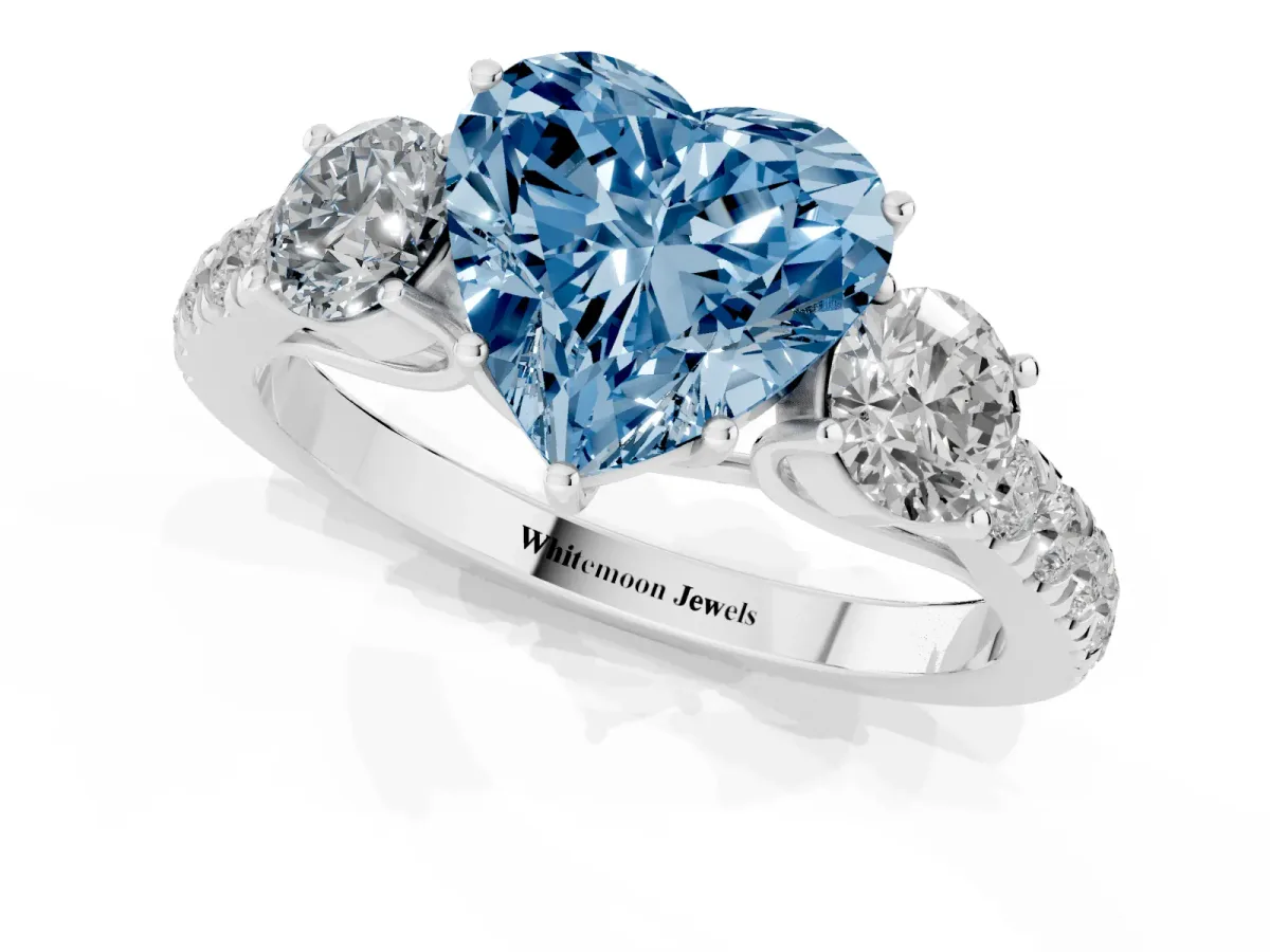 Fancy Blue Heart Cut Cut Diamond Three-Stone Ring with Round Side Stones and Pavé Band Platinum
