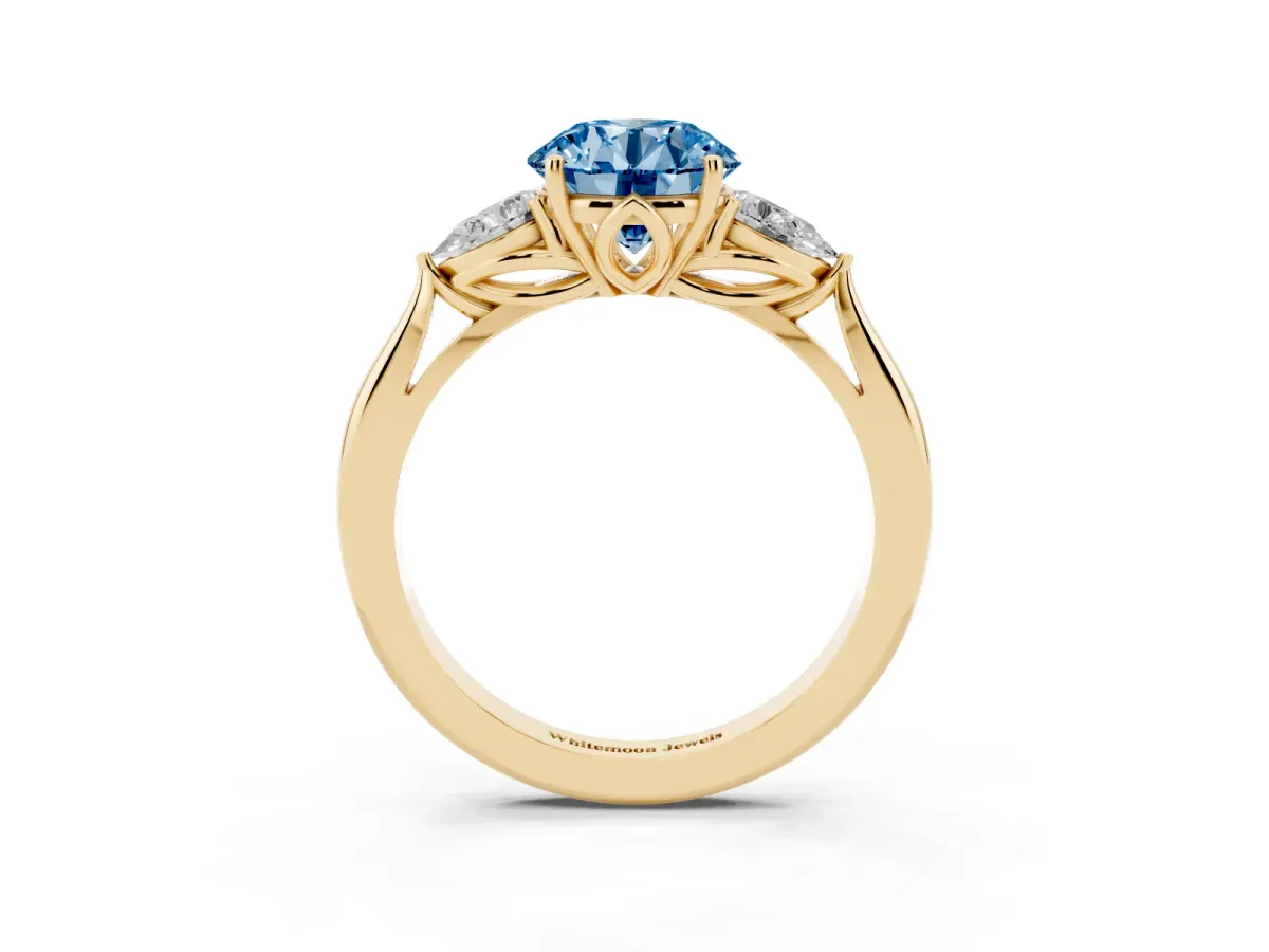 Fancy Blue Round Cut Diamond Three-Stone Ring with Pear Side Stones and Prong Setting Yellow gold