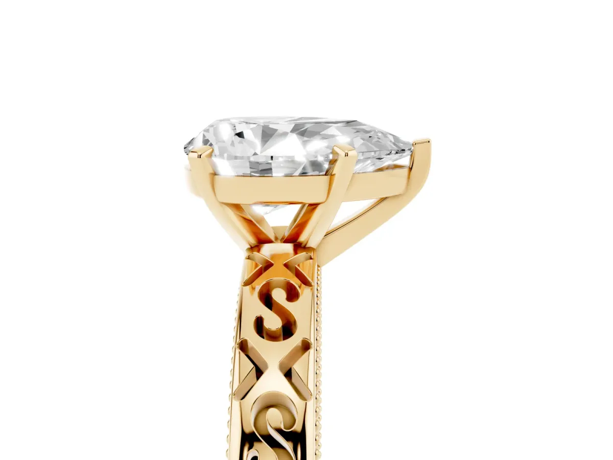 Pear Cut Solitaire Engagement Ring with Scrollwork Band and Four-Prong Setting Yellow gold
