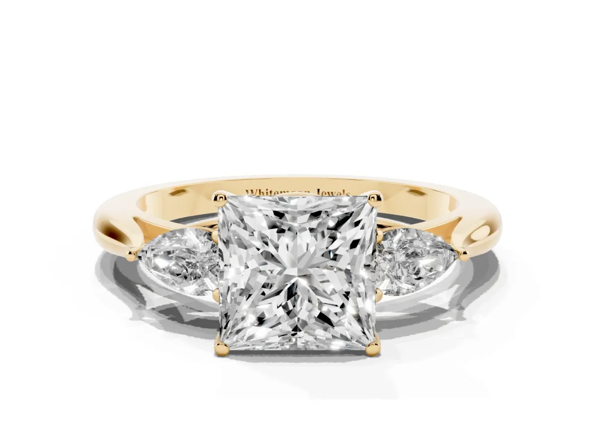 Three-Stone Princess Cut Diamond Ring with Pear Side Stones in Four-Prong Setting Yellow gold