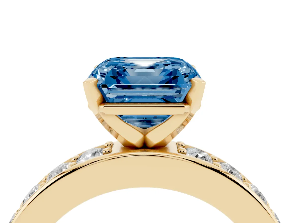 Fancy Blue Asscher Cut Diamond Engagement Ring with Channel Set Round Band and Prong Setting Yellow gold
