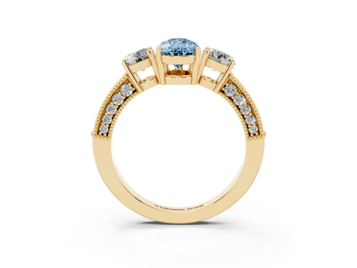 Fancy Blue Pear Cut Three-Stone Diamond Ring with Pavé Band and Four-Prong Setting Yellow gold