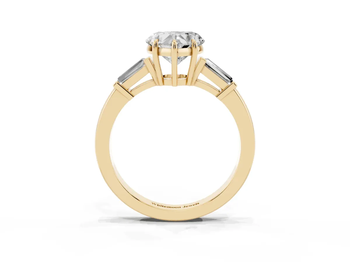 Heart Cut Diamond Three-Stone Ring with Tapered Baguette Side Stones and Prong Setting Yellow gold