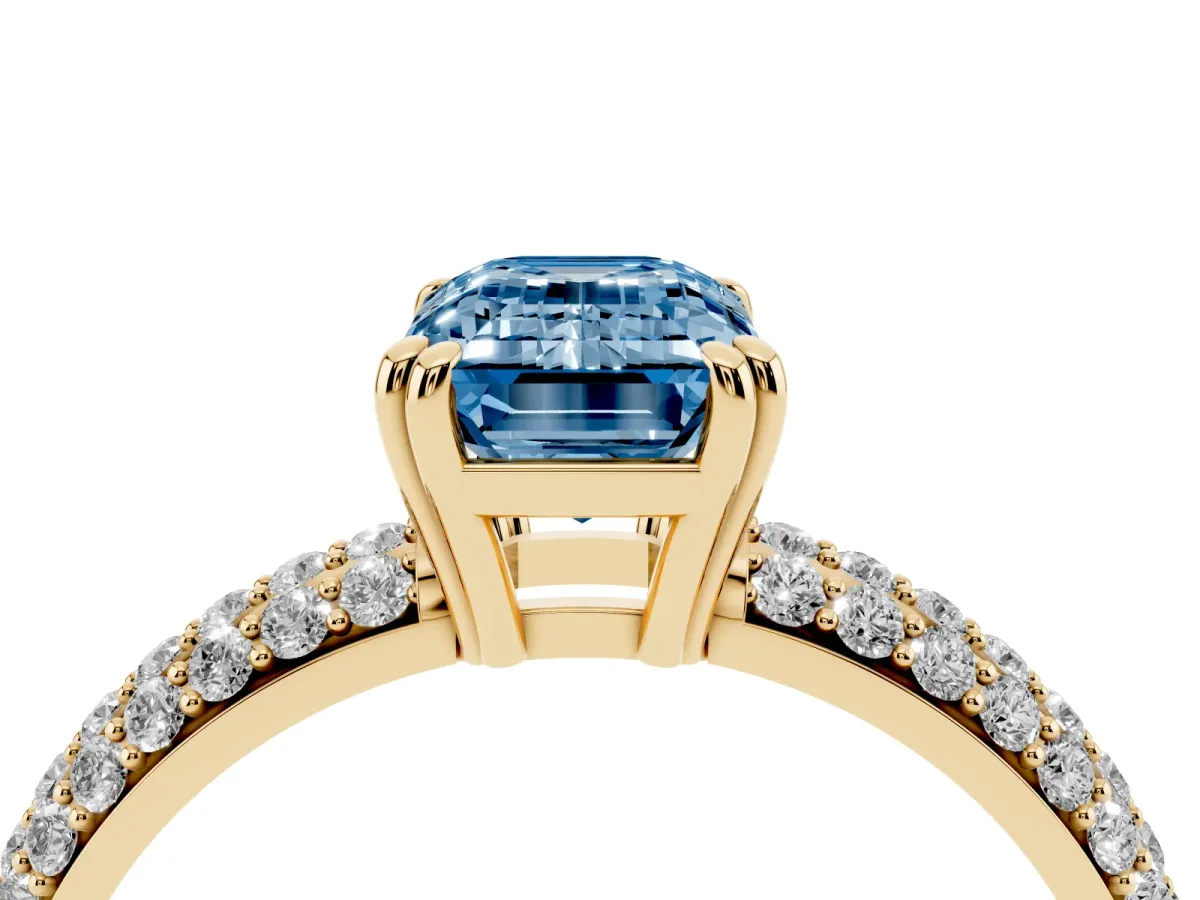 Fancy Blue Emerald Cut Diamond Solitaire Ring with Multi-Row Round Pavé Band and Prong Setting Yellow gold