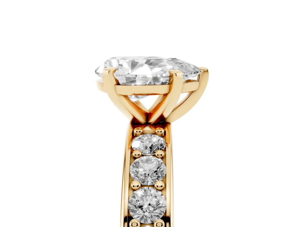 Pear Cut Diamond Engagement Ring with Channel Set Round Band and Prong Setting Yellow gold