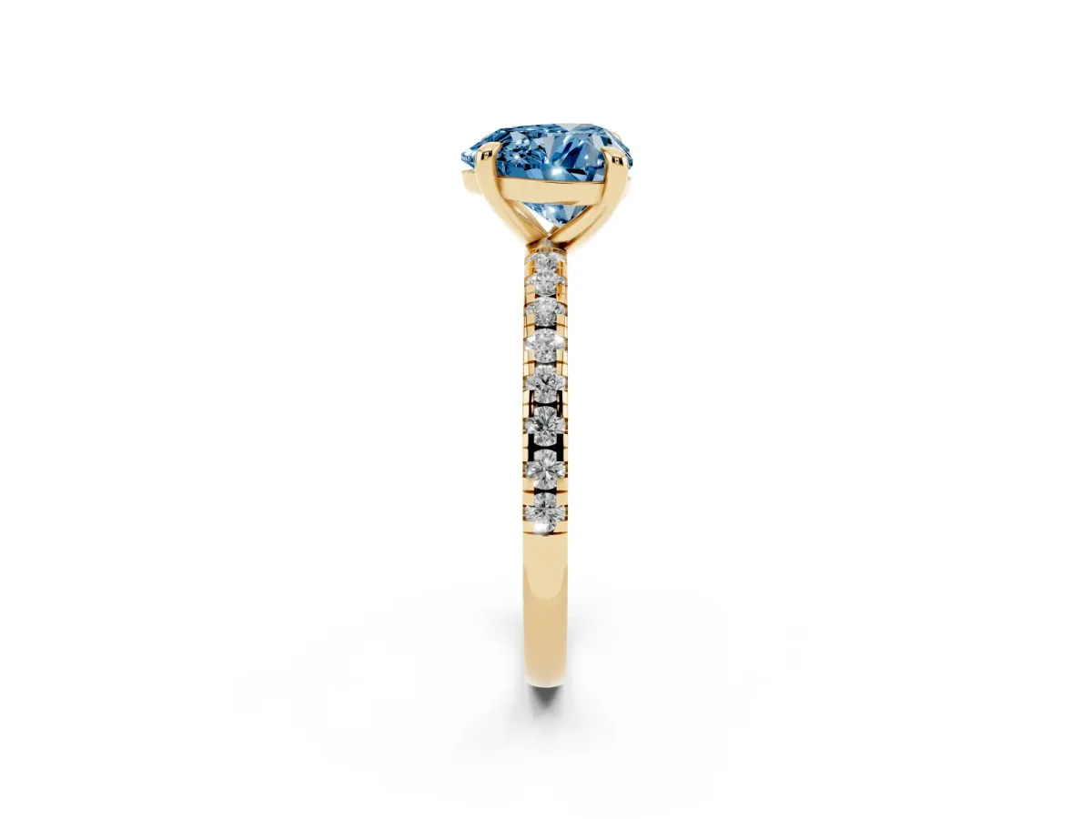 Fancy Blue Heart Cut Diamond Brilliant Solitaire Ring with Pavé Band and Four-Prong Setting Yellow gold