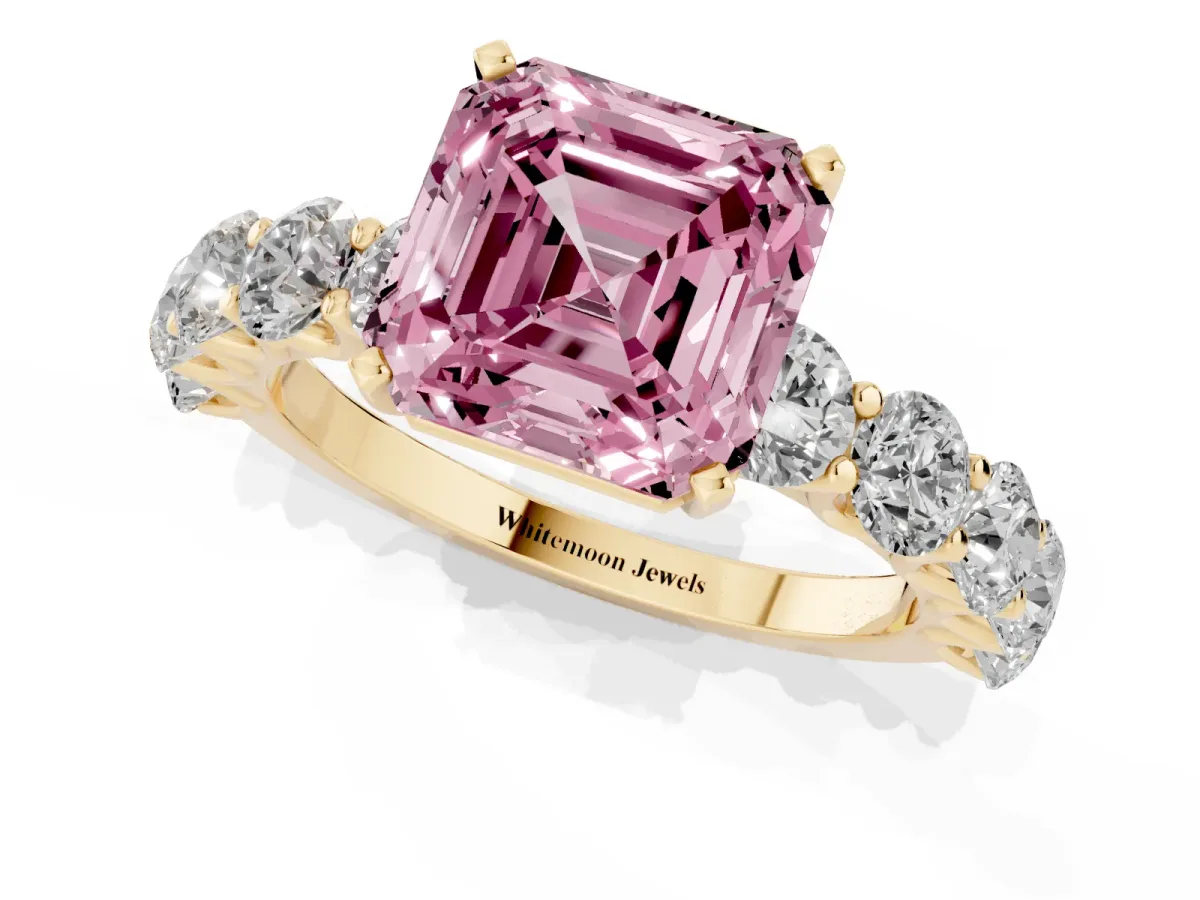 Fancy Pink Asscher Cut Diamond Prong Setting with Side Stones on a Pave Band Yellow gold