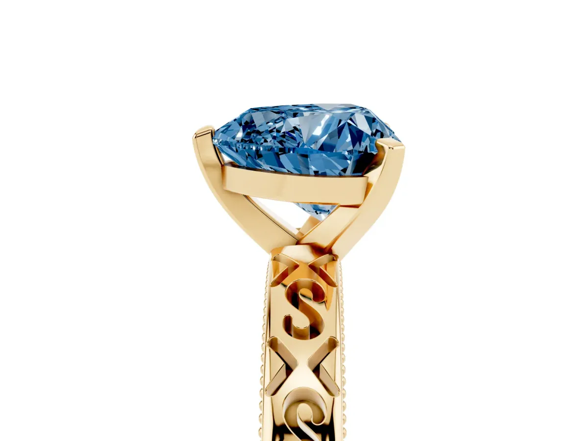 Fancy Blue Heart Cut Solitaire Engagement Ring with Scrollwork Band and Four-Prong Setting Yellow gold