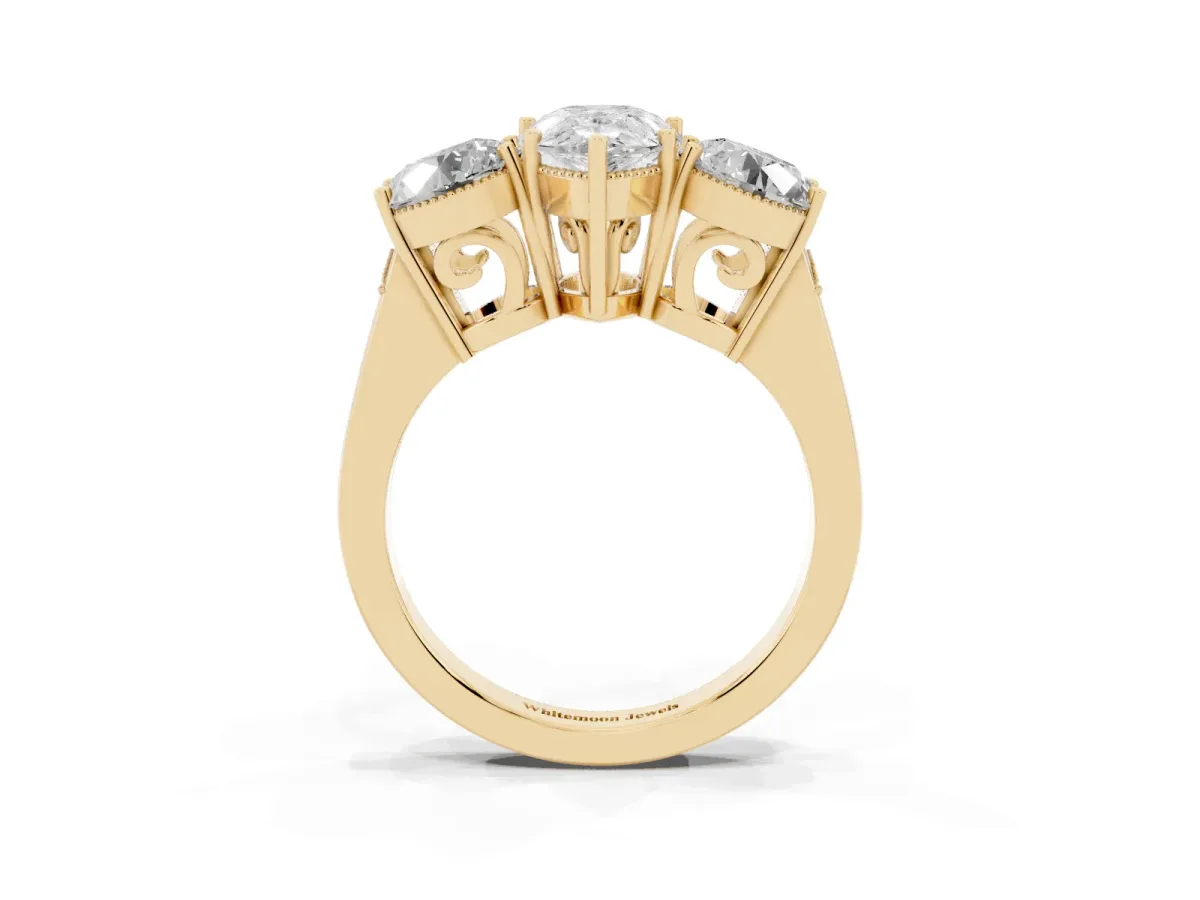 Three-Stone Pear Cut Diamond Engagement Ring with Prong Setting on a Classic Band Yellow gold