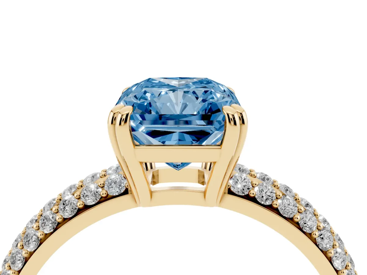 Fancy Blue Radiant Cut Diamond Solitaire Ring with Multi-Row Round Pavé Band and Prong Setting Yellow gold
