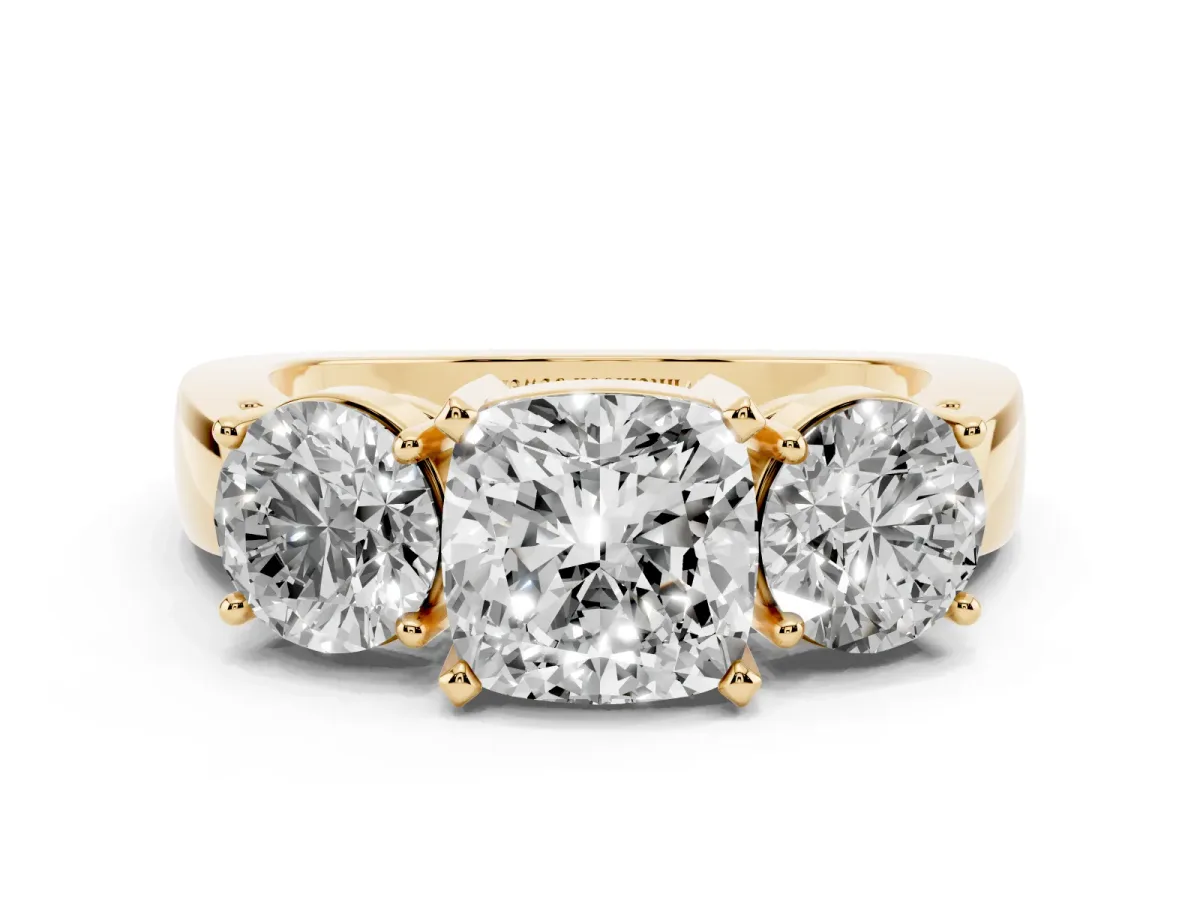 Three-Stone Cushion Cut Diamond Ring with Round Side Stones, Classic Band, and Four-Prong Setting Yellow gold