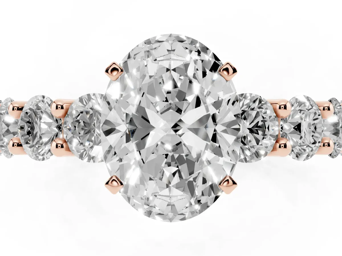 Oval Cut Diamond Prong Setting with Side Stones on a Pave Band Rose gold