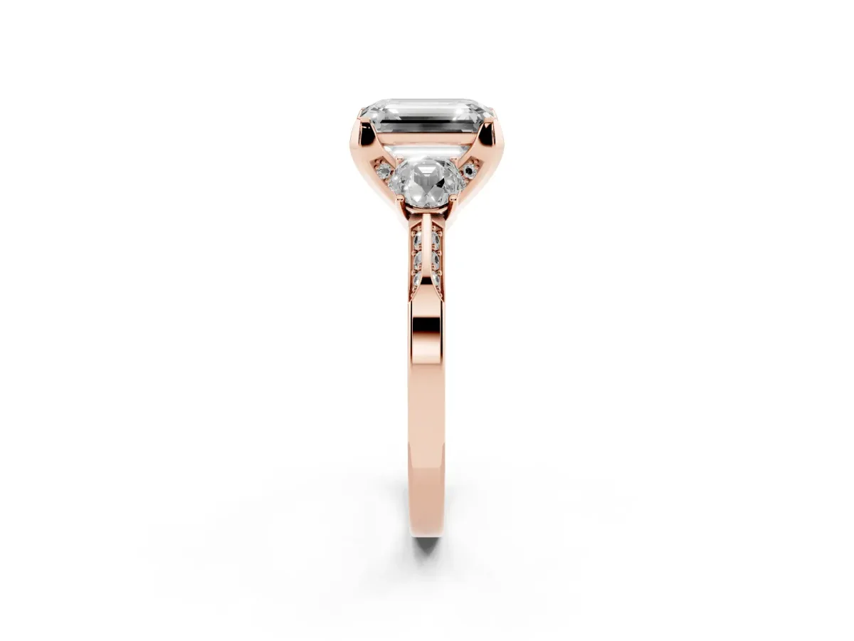 Fancy Pink Emerald Cut Brilliant Three-Stone Diamond Ring with Pavé Band and Four-Prong Setting Rose gold