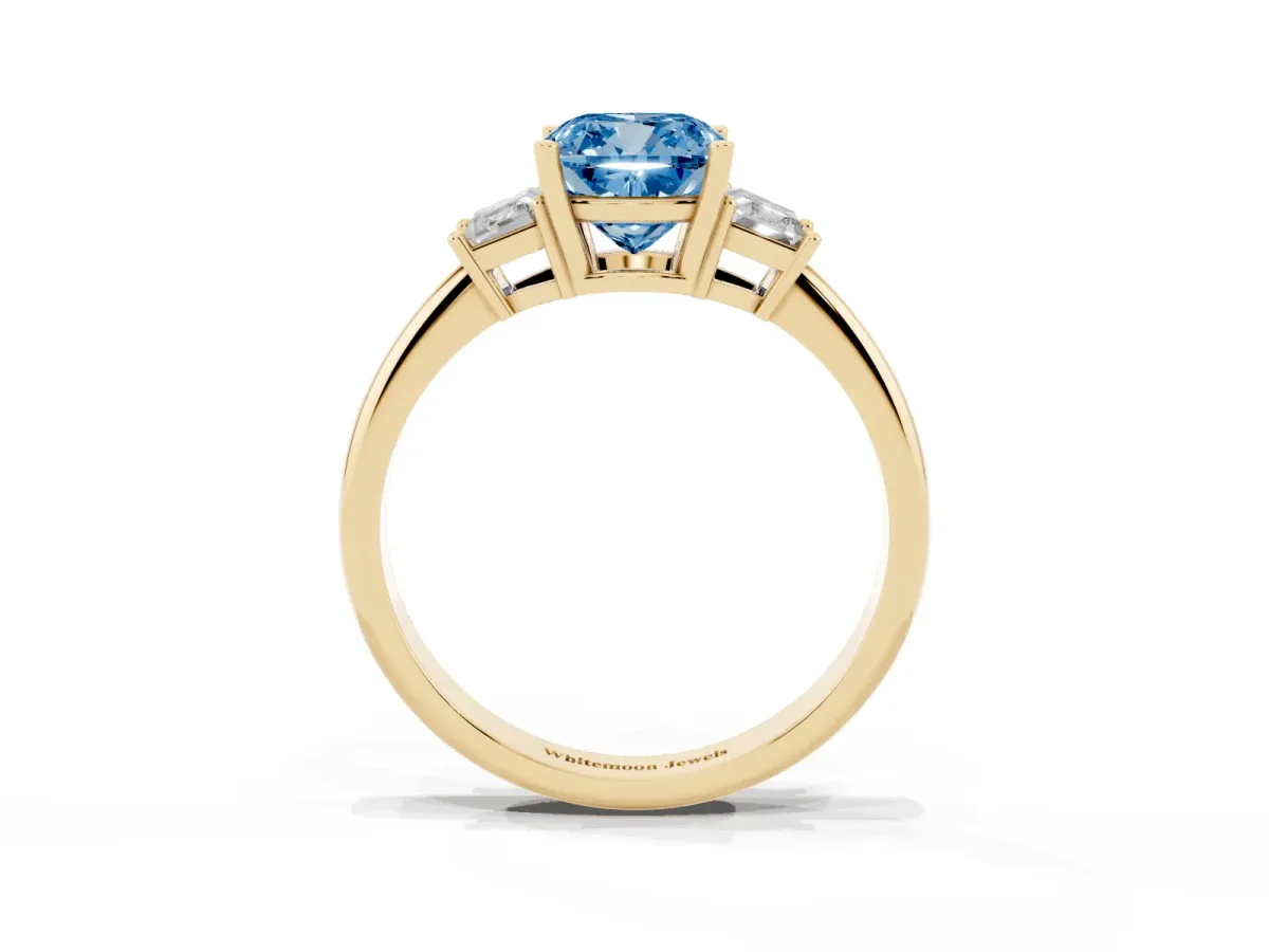 Fancy Blue Cushion Cut Diamond Three-Stone Ring with Trapezoid Side Stones and Prong Setting Yellow gold