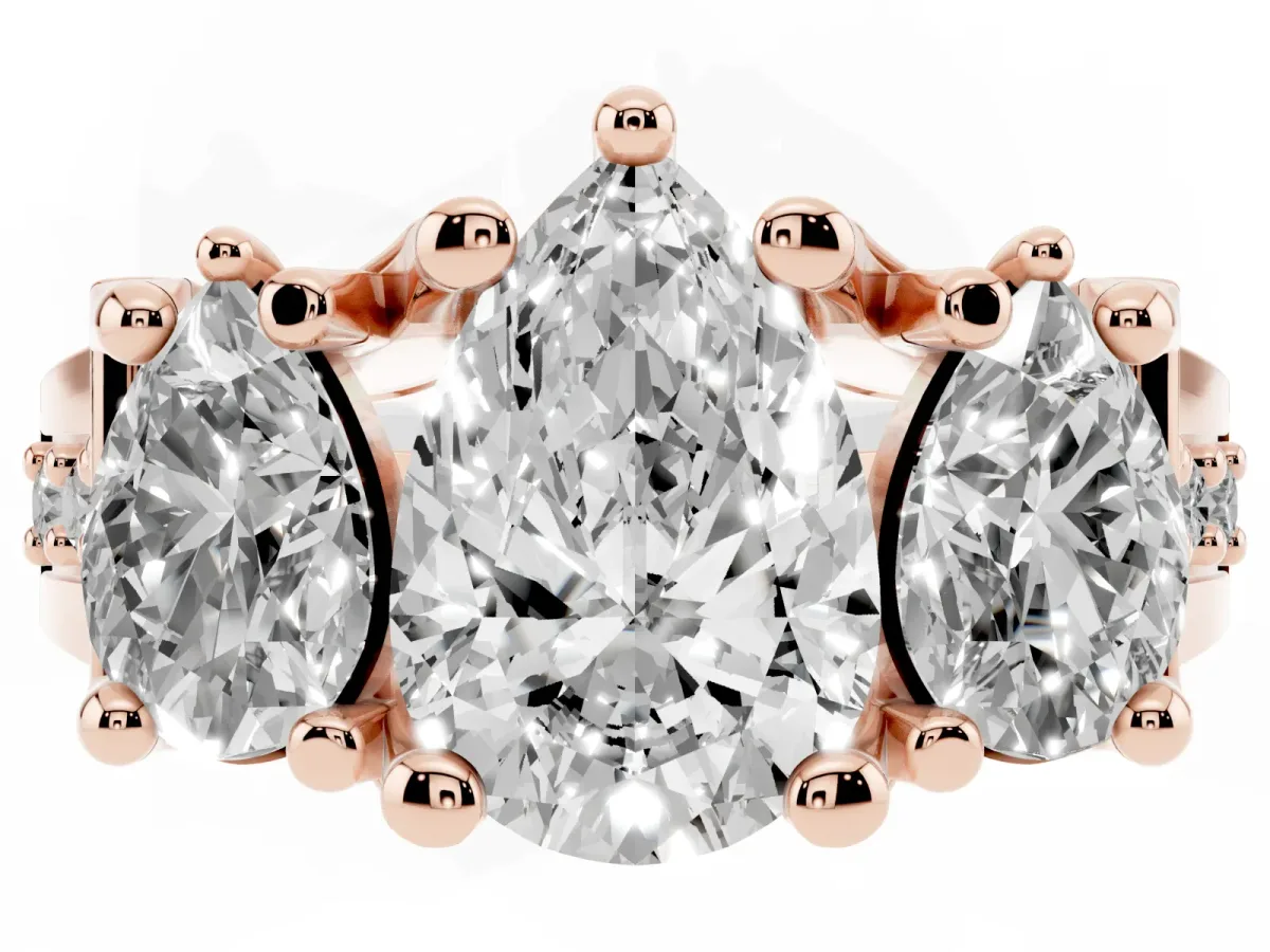 Pear Cut Diamond Three-Stone Ring with Channel Set Band and Four-Prong Setting Rose gold