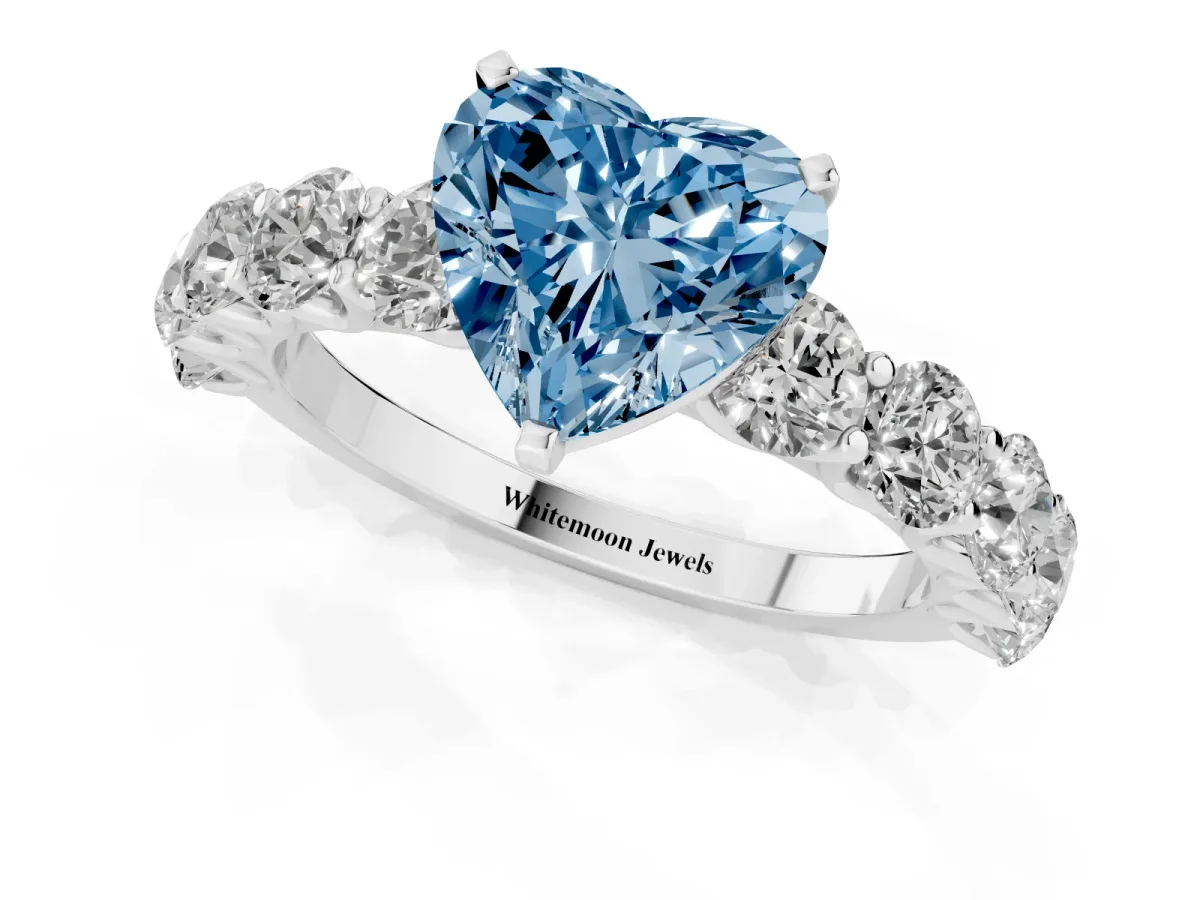 Fancy Blue Heart Cut Diamond Prong Setting with Side Stones on a Pave Band Silver