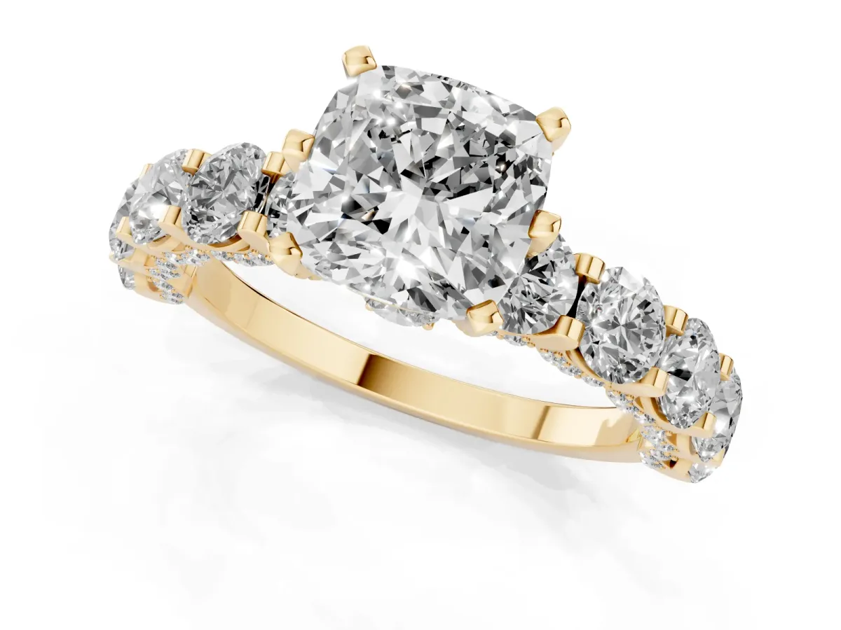 Cushion Cut Diamond Side Stone Engagement Ring with Four-Prong Setting Yellow gold
