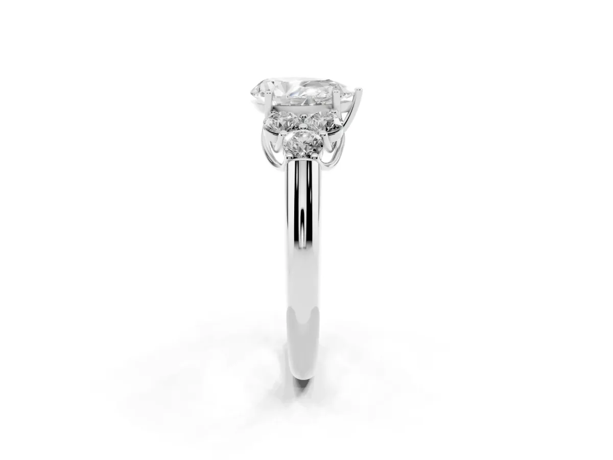 Pear Cut Cut Diamond Cluster Ring with Round Accent Stones and Prong Setting on a Classic Band White gold