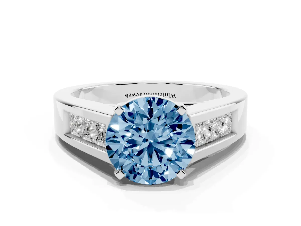Fancy Blue Round Cut Cut Channel Set Solitaire Ring with Four-Prong Setting Silver
