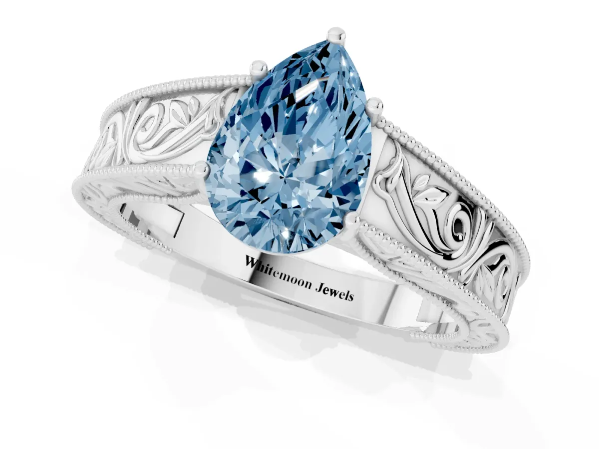 Fancy Blue Pear Cut Diamond Solitaire Ring with Engraved Band and Four-Prong Setting White gold