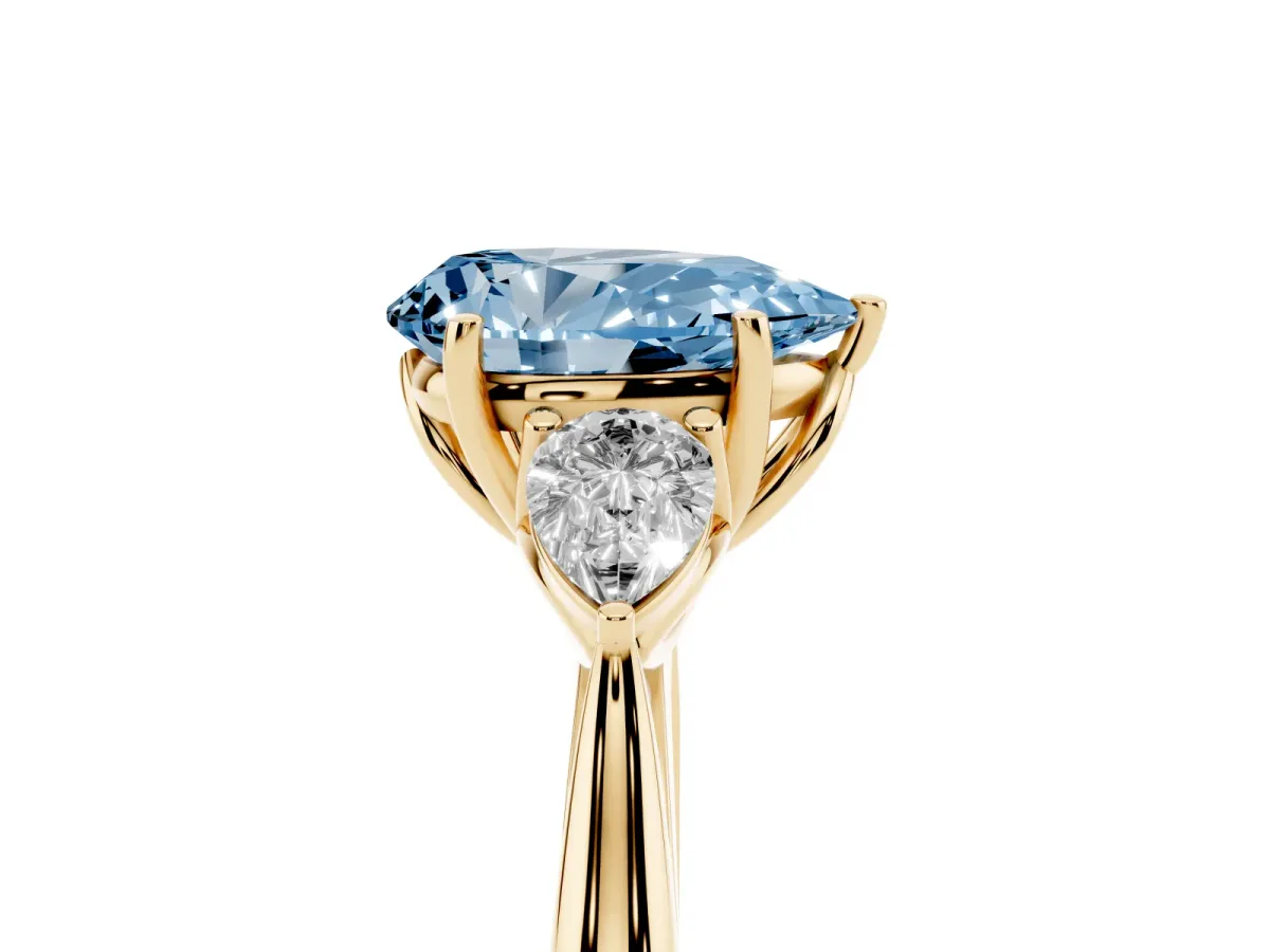 Fancy Blue Three-Stone Pear Cut Diamond Ring with Pear Side Stones in Four-Prong Setting Yellow gold