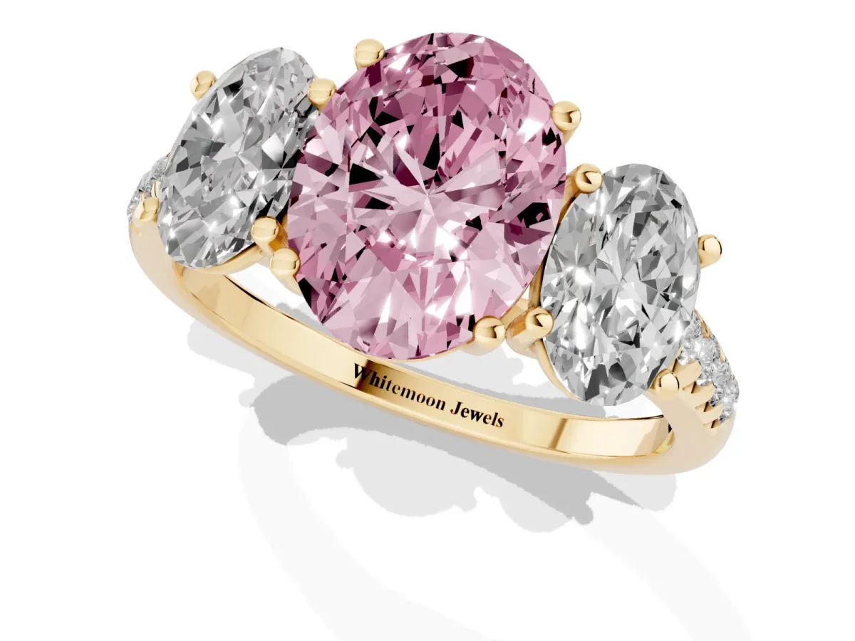 Fancy Pink Three-Stone Oval Cut Diamond Ring with Round Pavé Band and Prong Setting Yellow gold