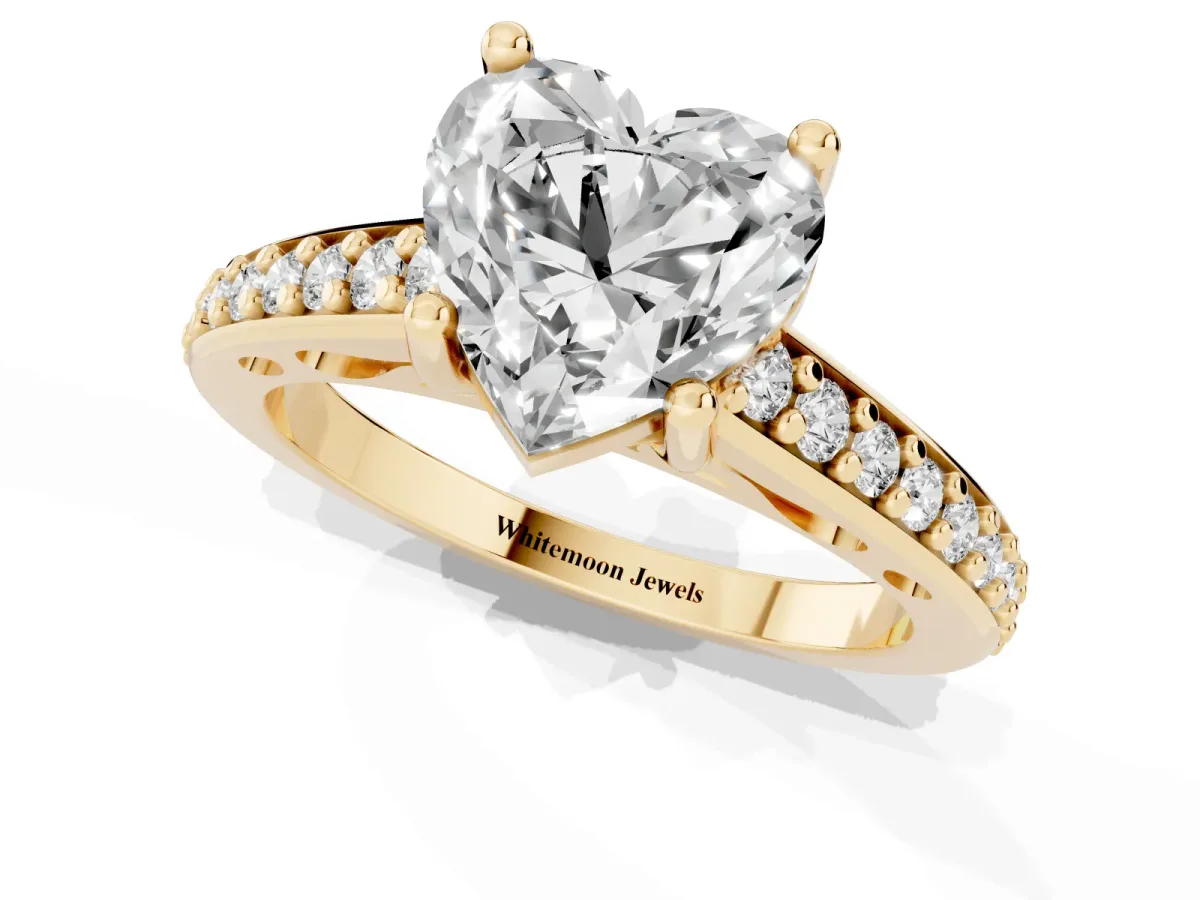Heart Cut Solitaire Prong Set Diamond Engagement Ring with Pave Band Yellow gold