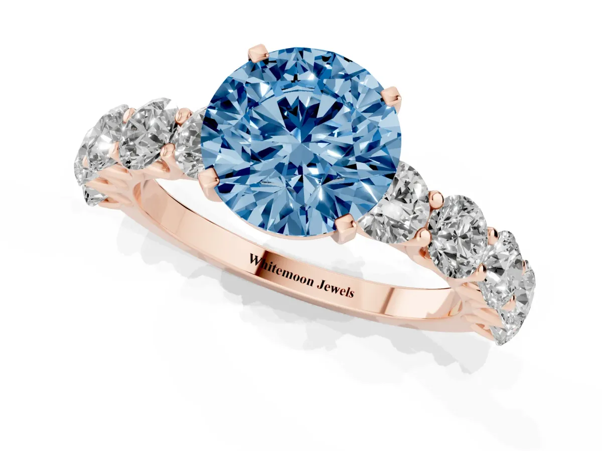 Fancy Blue Round Cut Diamond Prong Setting with Side Stones on a Pave Band Rose gold