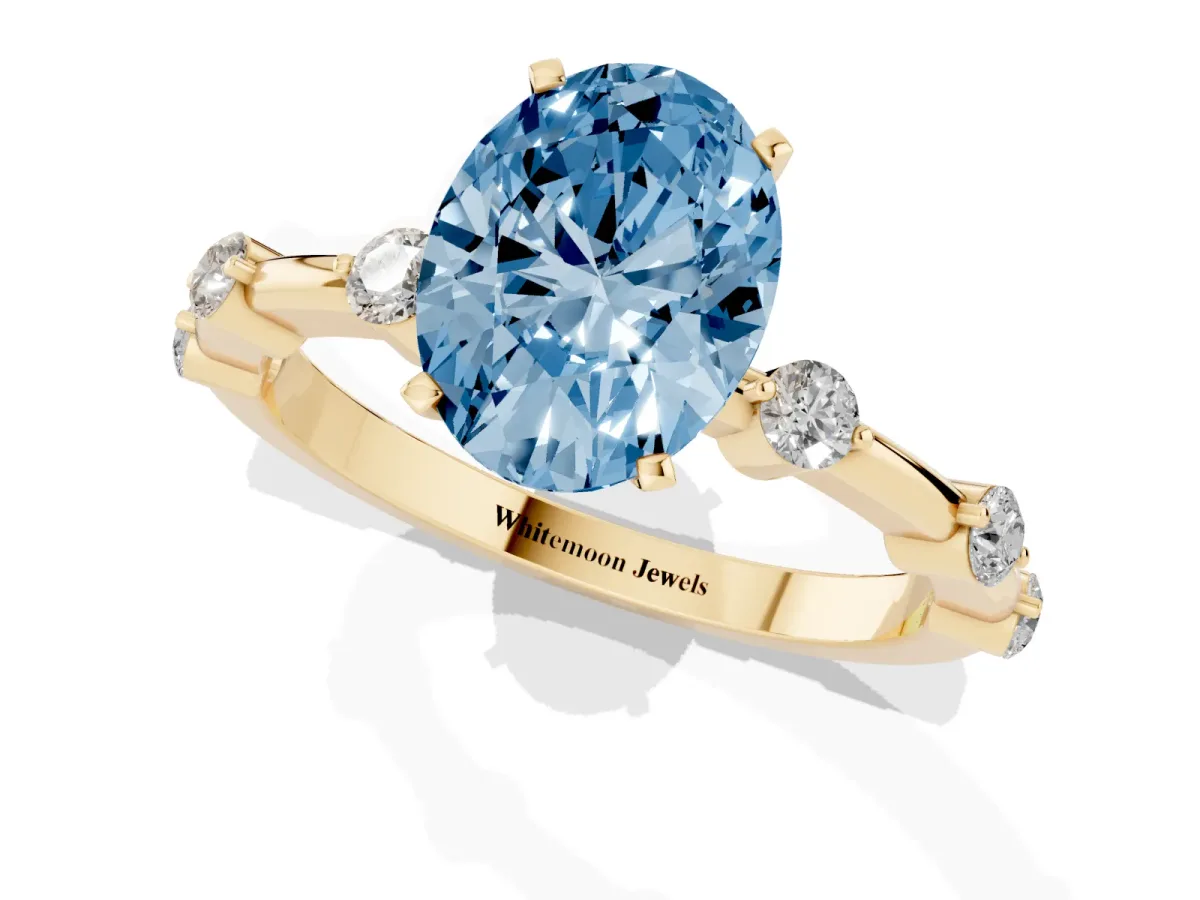 Fancy Blue Oval Cut Solitaire Diamond Ring with Bezel Set Side Stones and Prong Setting Yellow gold