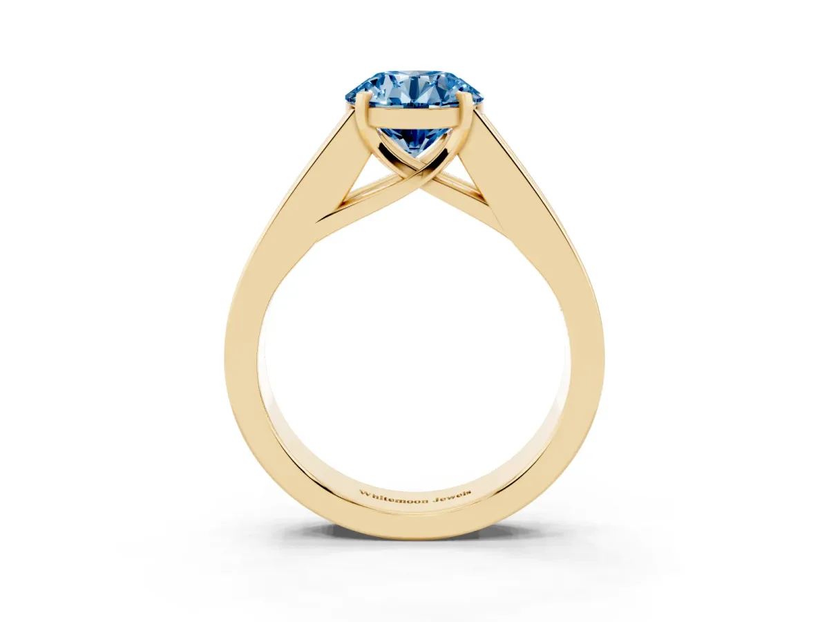 Fancy Blue Round Cut Cut Channel Set Solitaire Ring with Four-Prong Setting Yellow gold