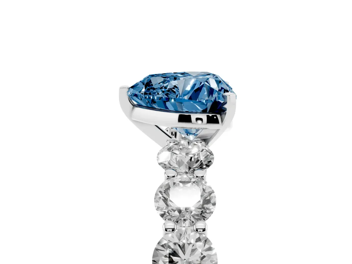 Fancy Blue Heart Cut Diamond Prong Setting with Side Stones on a Pave Band Silver