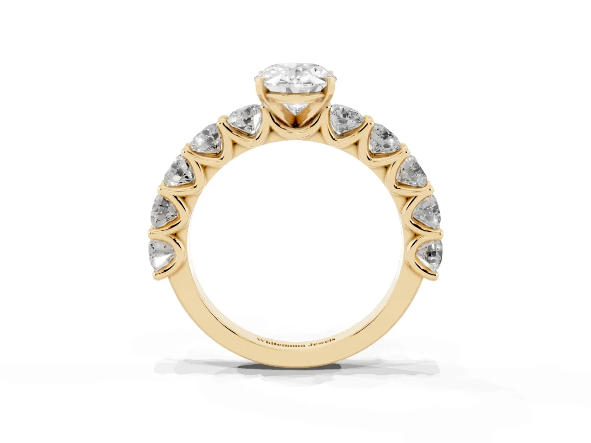 Oval Cut Diamond Prong Setting with Side Stones on a Pave Band Yellow gold