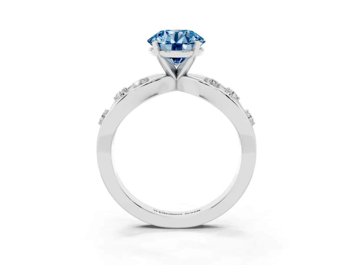 Fancy Blue Round Cut Cut Solitaire Diamond with Side Stones on Criss-Cross Band and Four-Prong Setting Silver