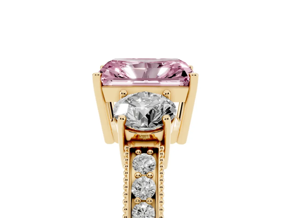 Fancy Pink Radiant Cut Three-Stone Diamond Ring with Pavé Band and Four-Prong Setting Yellow gold