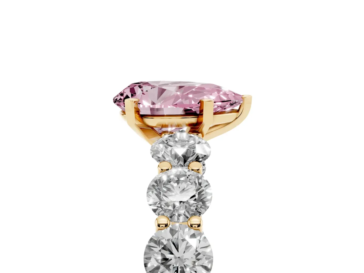 Fancy Pink Pear Cut Diamond Prong Setting with Side Stones on a Pave Band Yellow gold