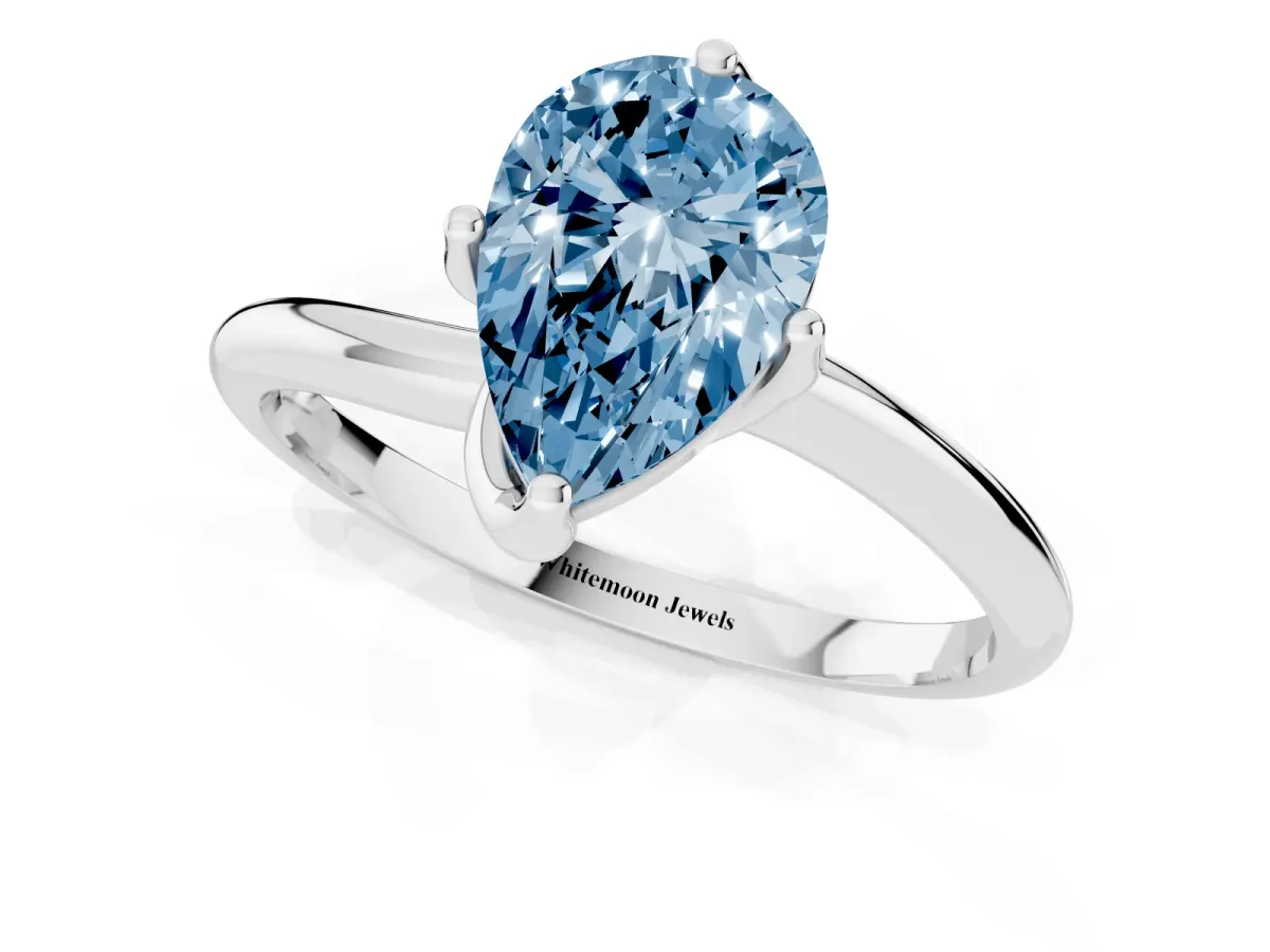 Fancy Blue Pear Cut Diamond Solitaire Engagement Ring with Four-Prong Setting and Classic Band Silver