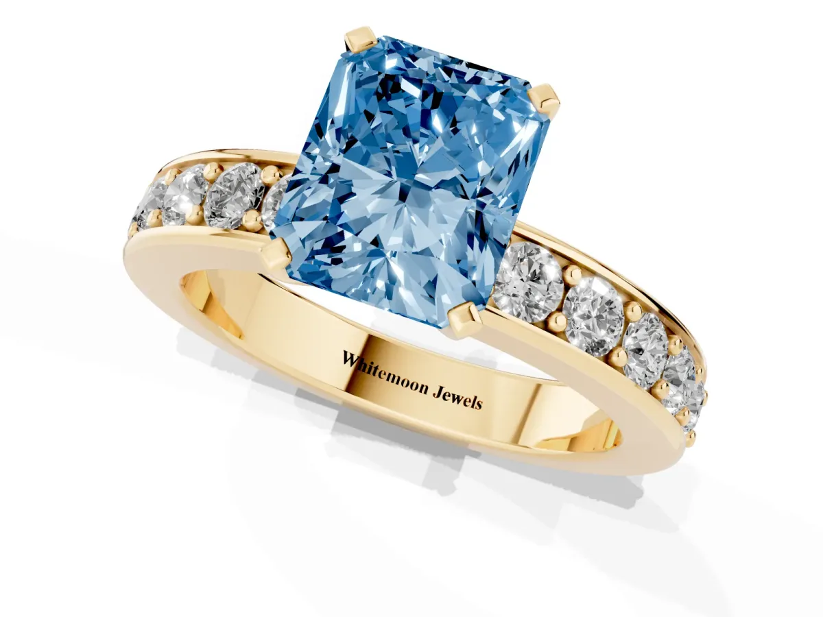 Fancy Blue Radiant Cut Diamond Engagement Ring with Channel Set Round Band and Prong Setting Yellow gold
