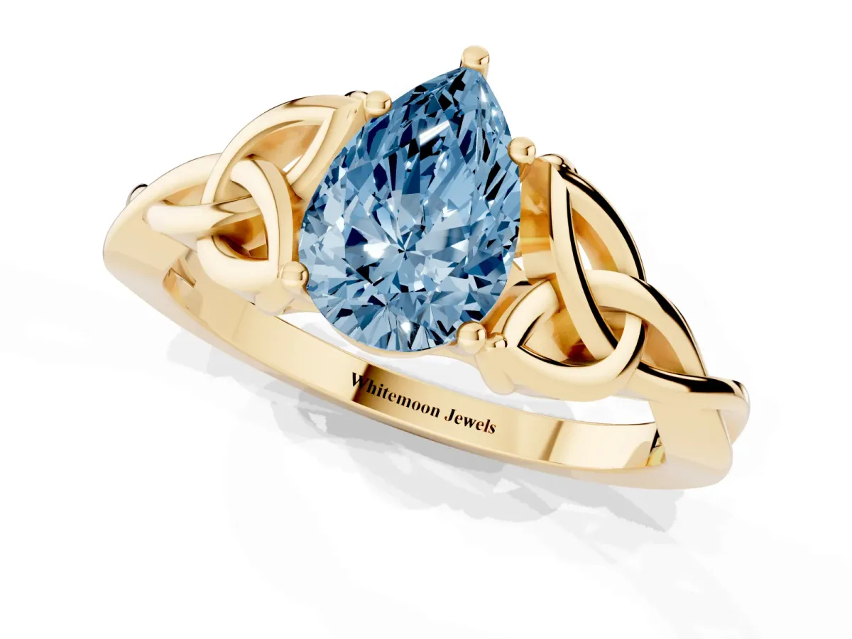Fancy Blue Pear Cut Diamond Solitaire Engagement Ring with Celtic Knot Band and Four-Prong Setting Yellow gold