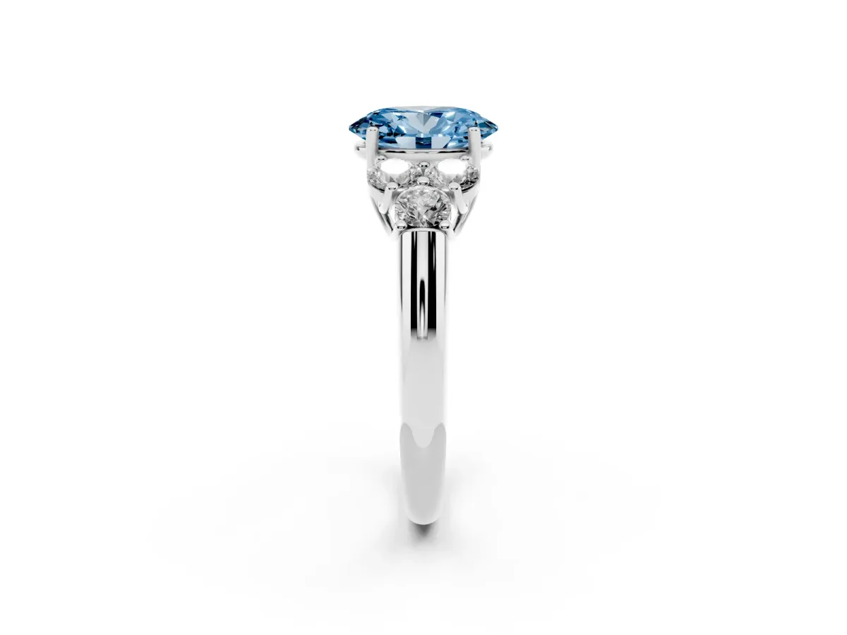 Fancy Blue Oval Cut Cut Diamond Cluster Ring with Round Accent Stones and Prong Setting on a Classic Band Silver