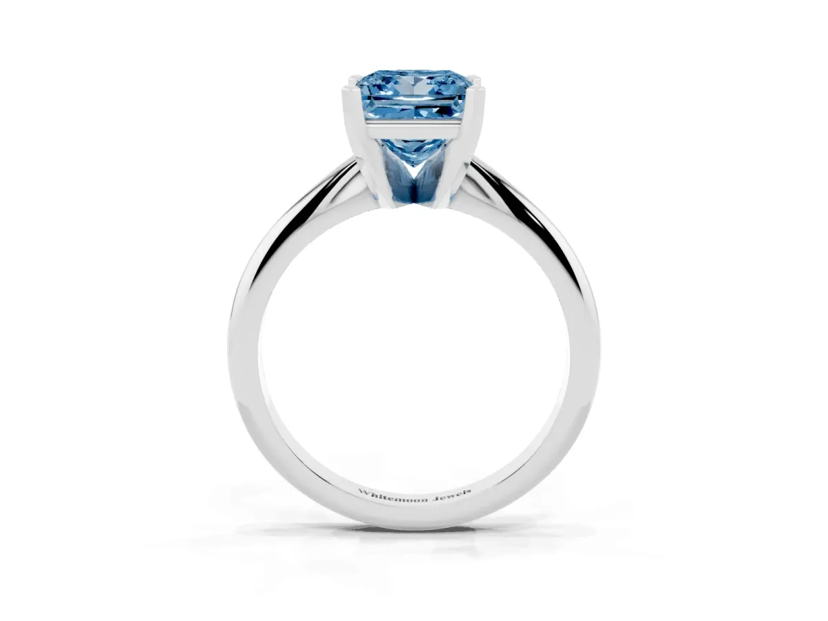 Fancy Blue Princess Cut Cut Solitaire Ring with Four-Prong Setting on a Classic Band Silver
