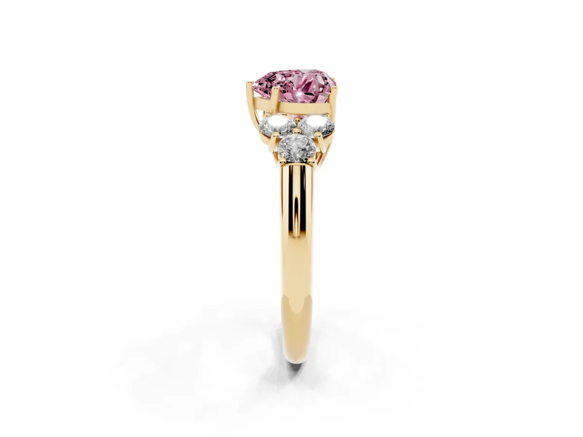 Fancy Pink Heart Cut Cut Diamond Cluster Ring with Round Accent Stones and Prong Setting on a Classic Band Yellow gold